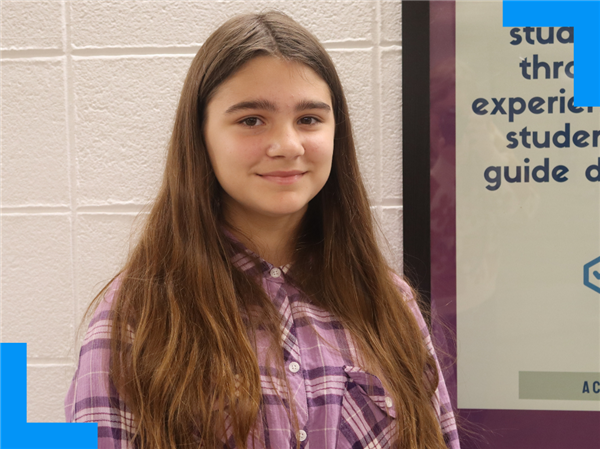  Kaylie smiles and poses for the camera at the Academy of Exploration.